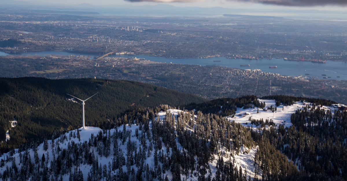 Wind turbine on a snow capped mountain